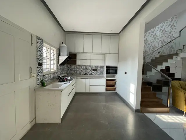 Modular kitchen with staircase beyond - Mr. Nagaraj project, Bangalore