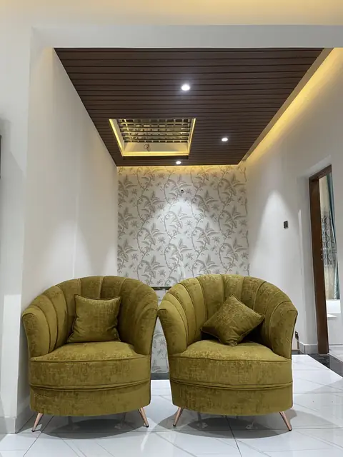 Two accent chairs under wooden ceiling - Mr. Nagaraj project, Bangalore