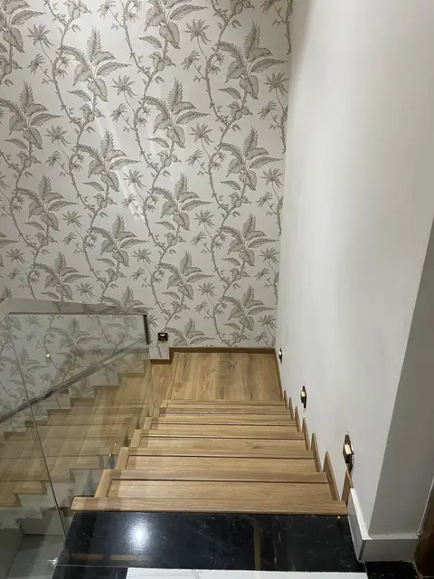 Staircase with wallpapered wall behind - Mr. Nagaraj project, Bangalore