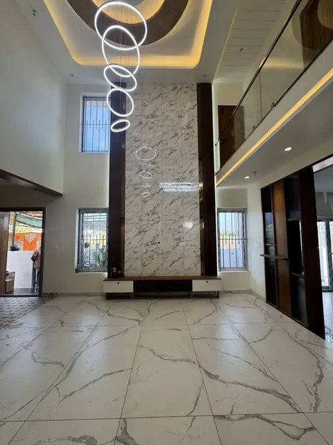 Lobby with stone-clad column and lighting - Mr. Ranjith project, Bangalore