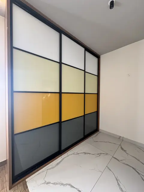Wardrobe with coloured glass shutter panels - Mr. Ranjith project, Bangalore