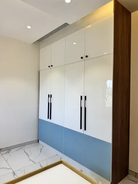 Two-tone wardrobe shutters with long handles - Mr. Ranjith project, Bangalore