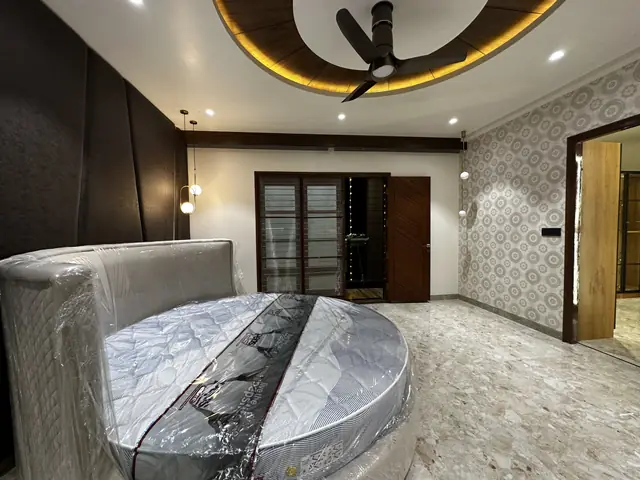Round bed with dark panelled headboard wall - Mr. Siddanth project, Bangalore