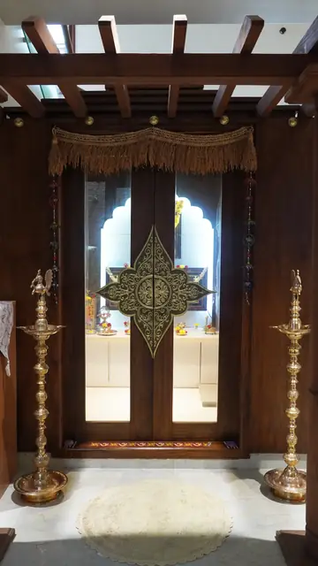 Pooja doors with brass lamps either side - Mr. Siddanth project, Bangalore