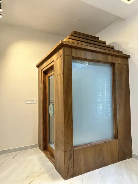 Wood-clad home lift enclosure with glass - Mr. Umesh project, Bangalore