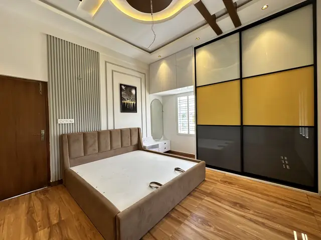 Coloured glass wardrobe beside wooden bed - Mr. Umesh project, Bangalore
