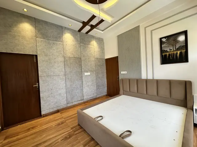 Bedroom with textured wall and wooden flooring - Mr. Umesh project, Bangalore
