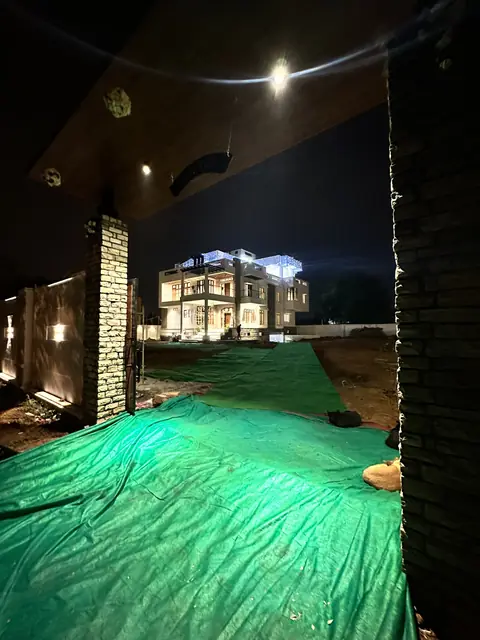 House facade lit at night from driveway - Mr. Willfred project, Bangalore