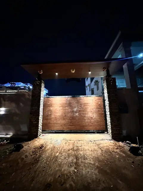 Compound entrance gate lit at night - Mr. Willfred project, Bangalore