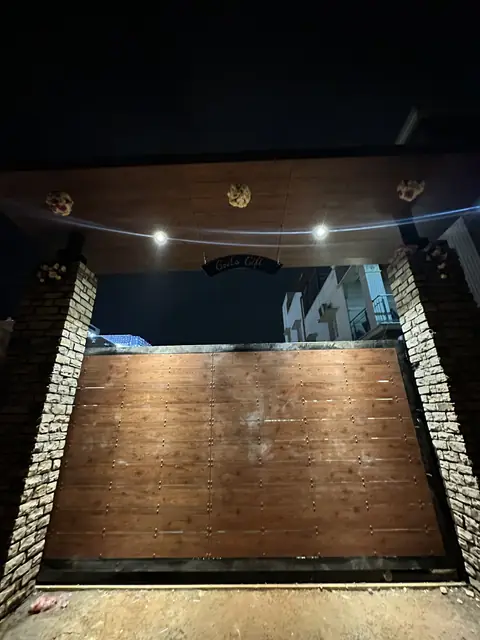 Timber gate and compound wall at night - Mr. Willfred project, Bangalore