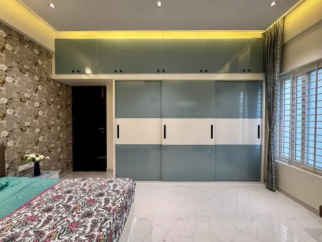 Bedroom with wardrobes and wallpapered wall - Mrs. Anitha project, Bangalore