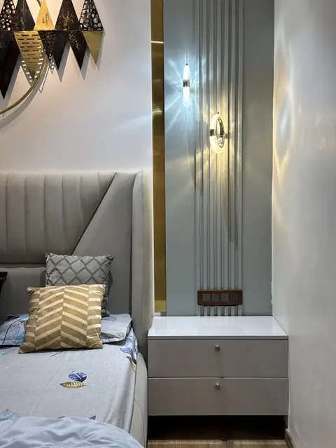 Bedside unit below fluted panelling and sconce - Ms. Rashmi project, Bangalore