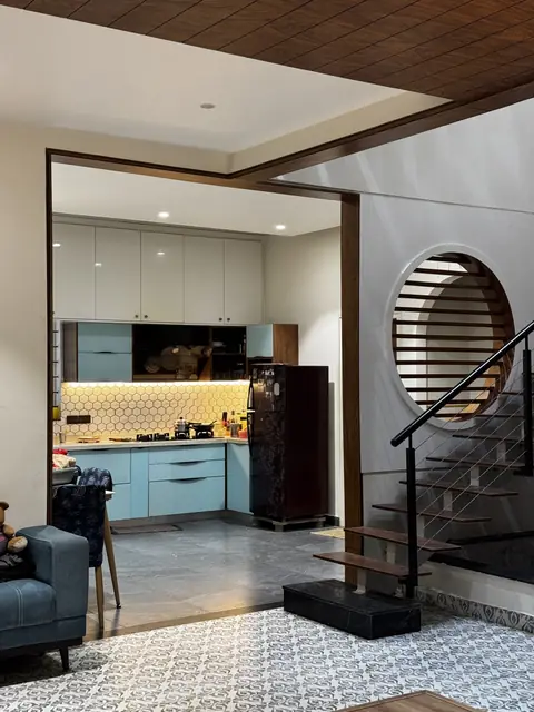 Modular kitchen viewed past the staircase - Ms. Rashmi project, Bangalore