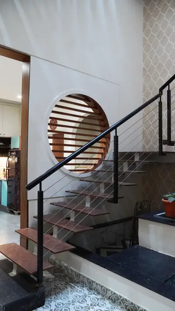 Staircase seen through circular louvred opening - Ms. Rashmi project, Bangalore